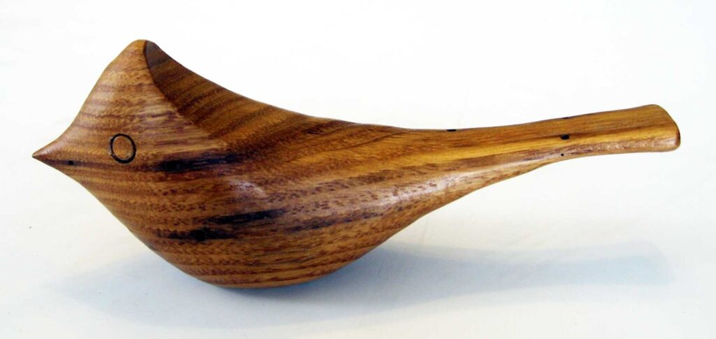 stylized american chestnut wood carving of a little bird by gary carver of carverscarvings