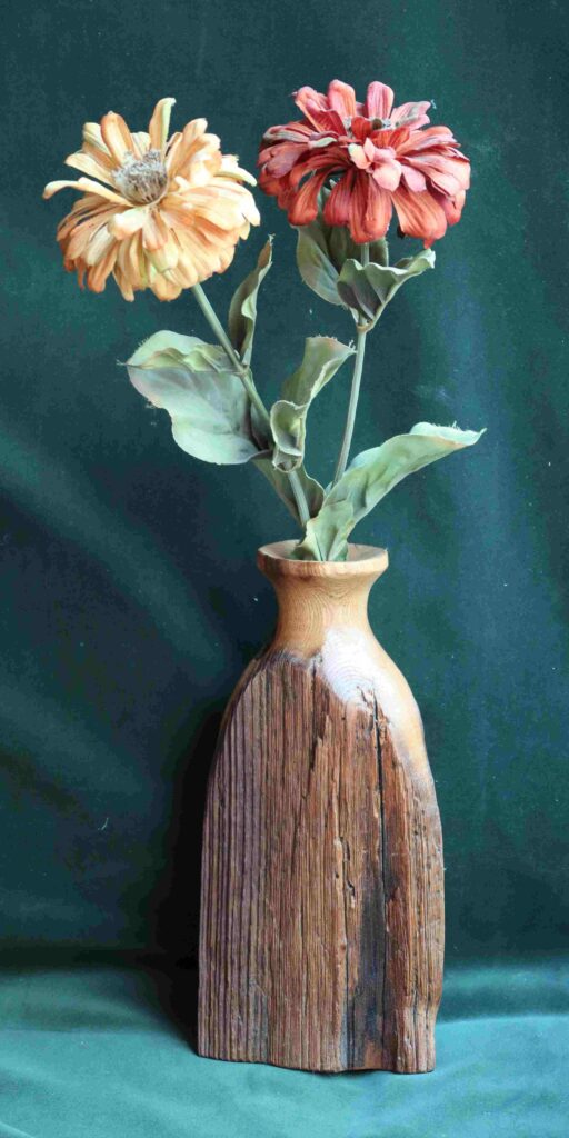 photograph of dried flowers in an american chestnut fence post dry vase wood carving by gary carver of carverscarvings