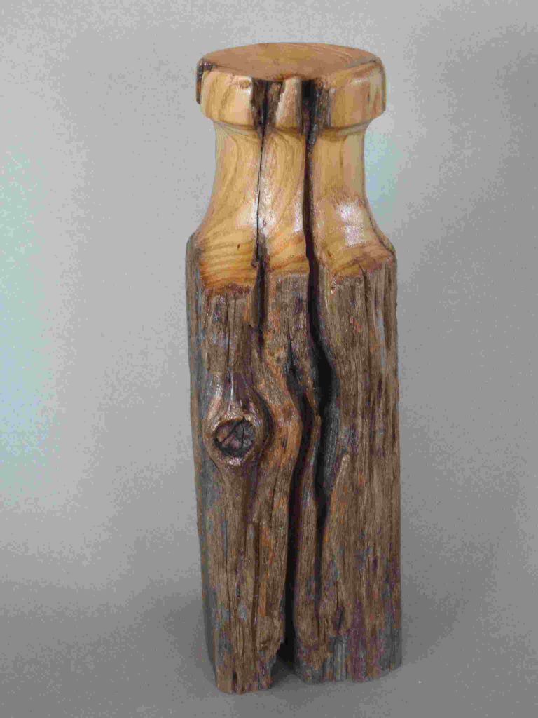 one stylized wood carving of a dry vase by gary carver of carverscarvings