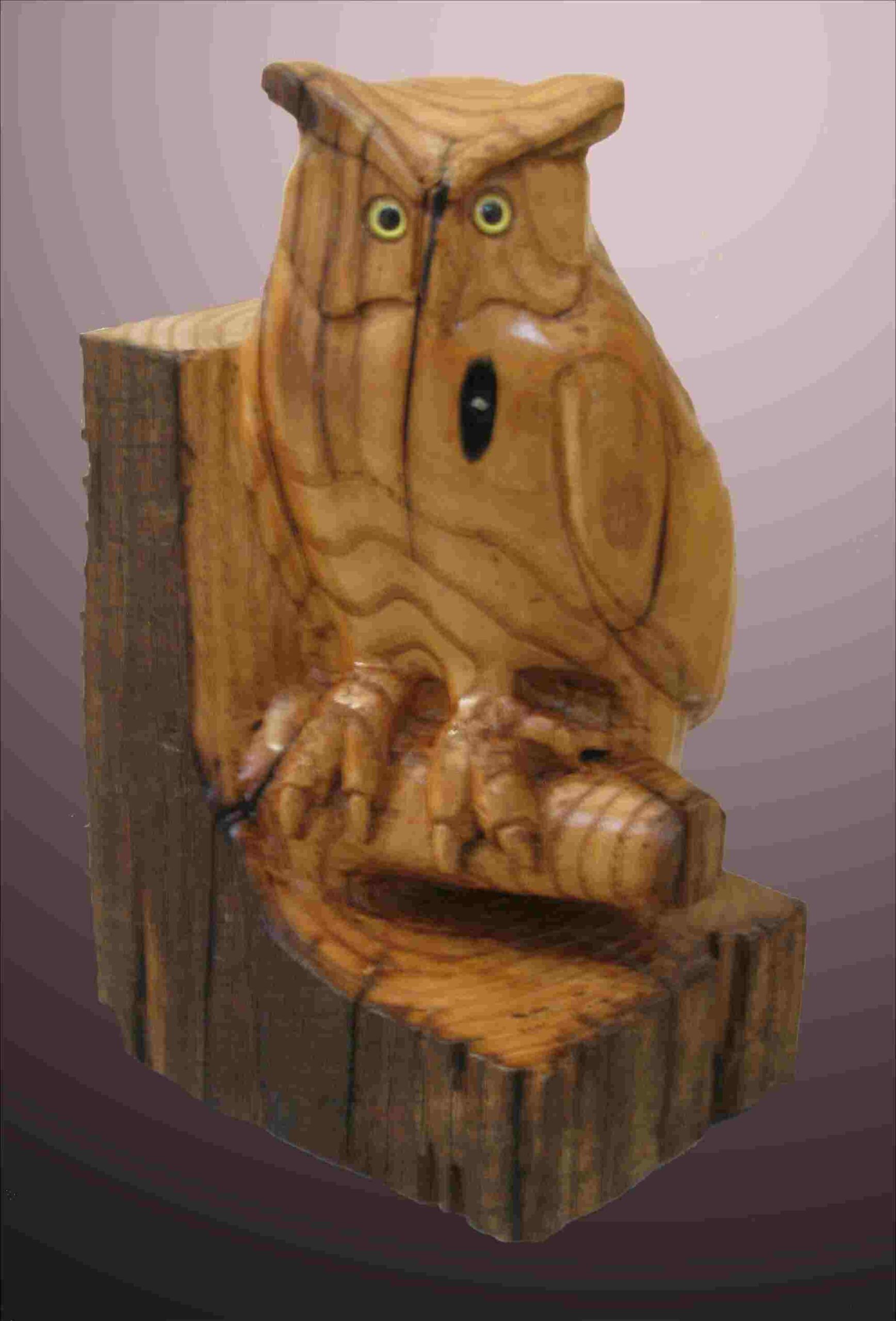 stylized chestnut wood carving of a great horned owl by gary carver of carverscarvings